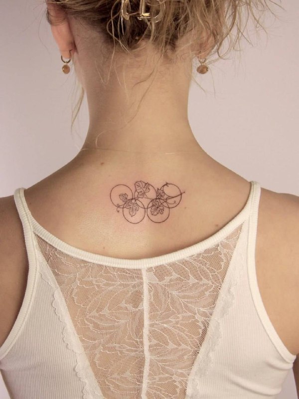 Nastya Metelkina's Olympic rings tattoo with grape leaves